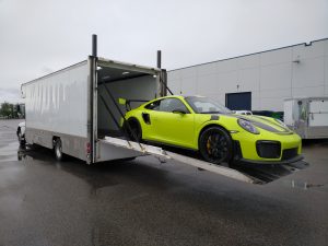 Acid Green Porsche GT2RS loading onto liftgate transporter