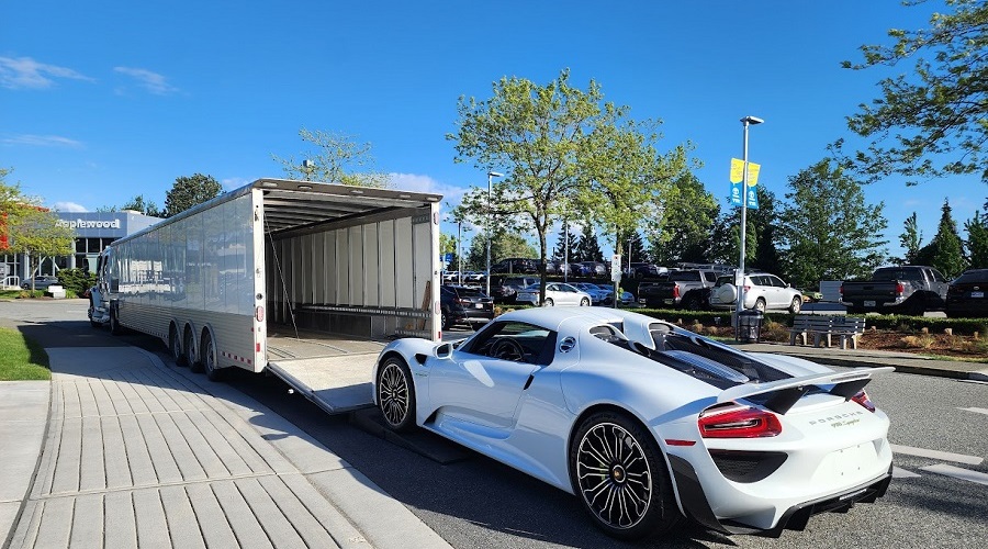 Porsche 918 Hypercar loading into enclosed auto transporter